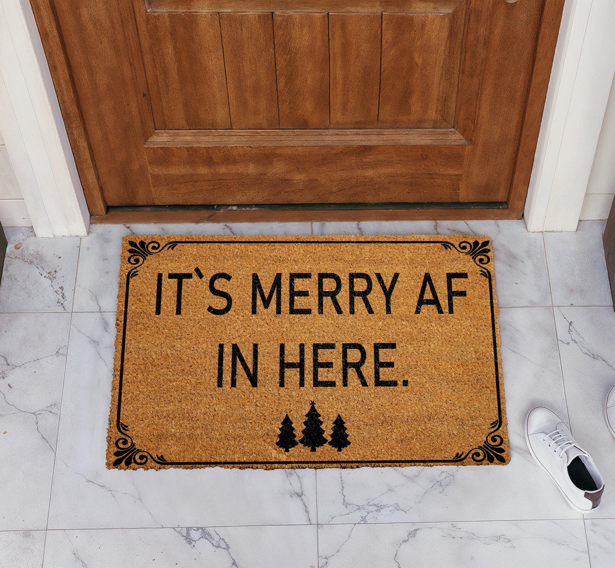 Doormat with "It’s merry AF in here" block lettering and three trees
