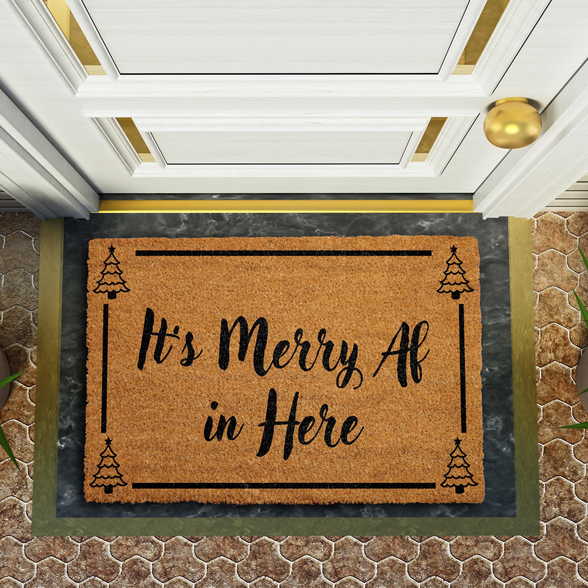 Doormat with "It’s merry AF in here" script lettering and a tree border