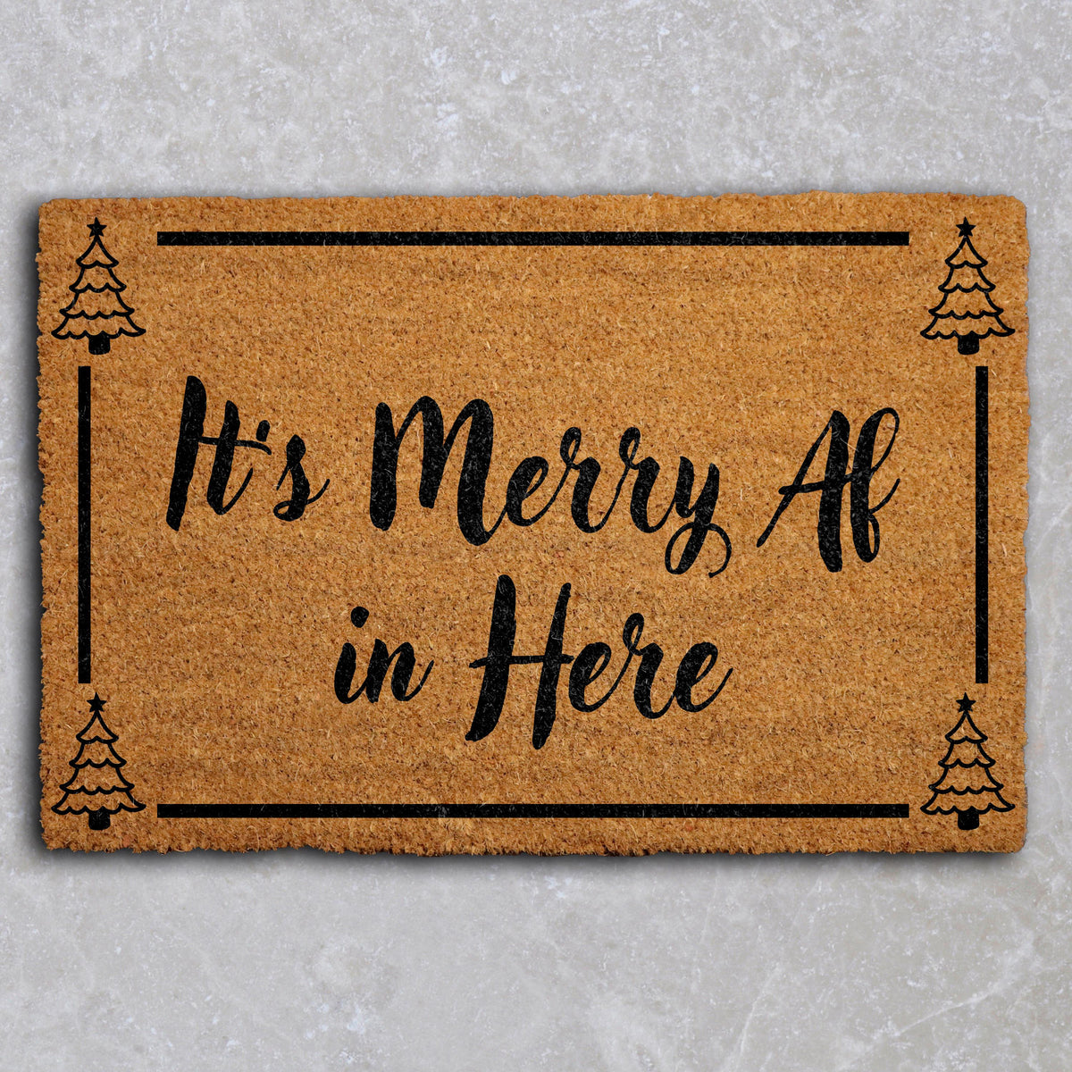 Doormat with "It’s merry AF in here" script lettering and a tree border