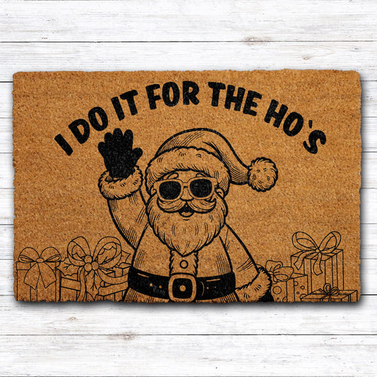 Doormat with Santa in sunglasses and "I do it for the ho’s" lettering