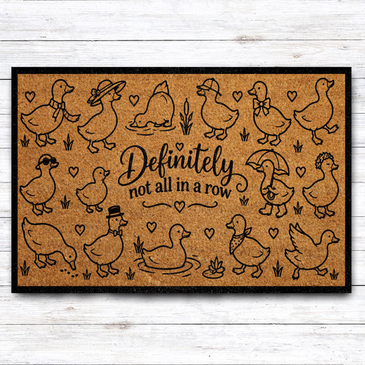 Doormat with dressed-up geese and "Definitely not all in a row" lettering