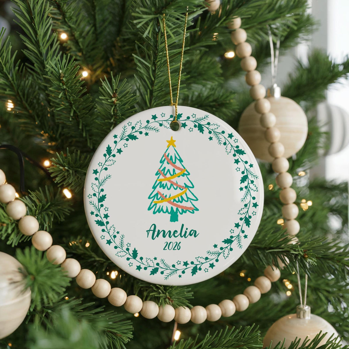 Round ornament with a Christmas tree and a personalized name
