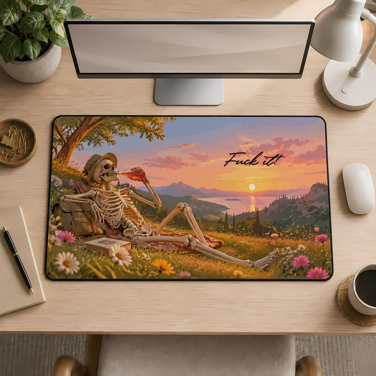 Desk mat with a reclining skeleton, landscape and "Fuck it" lettering