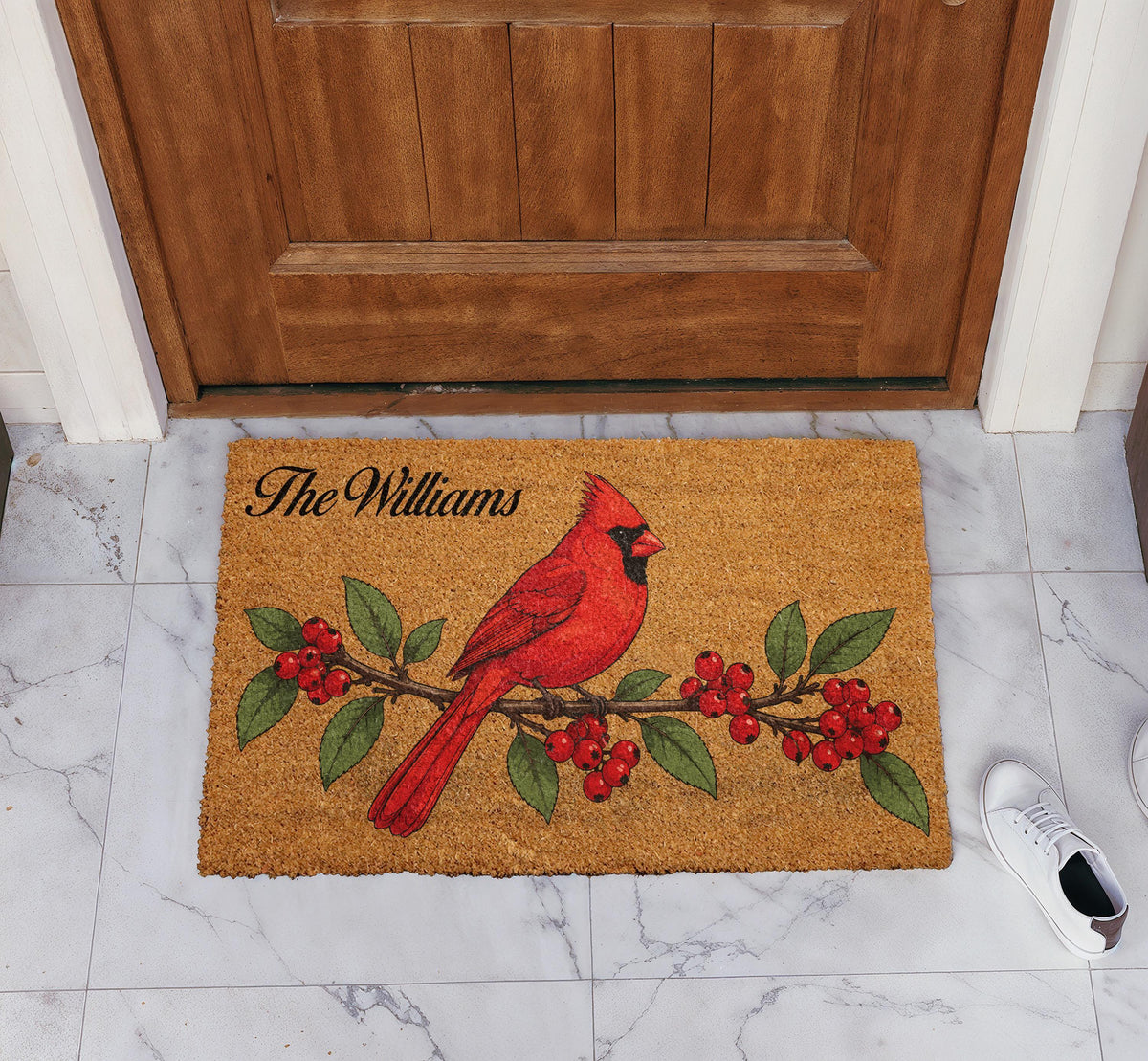 Doormat with a red cardinal on a berry branch and a personalized family name