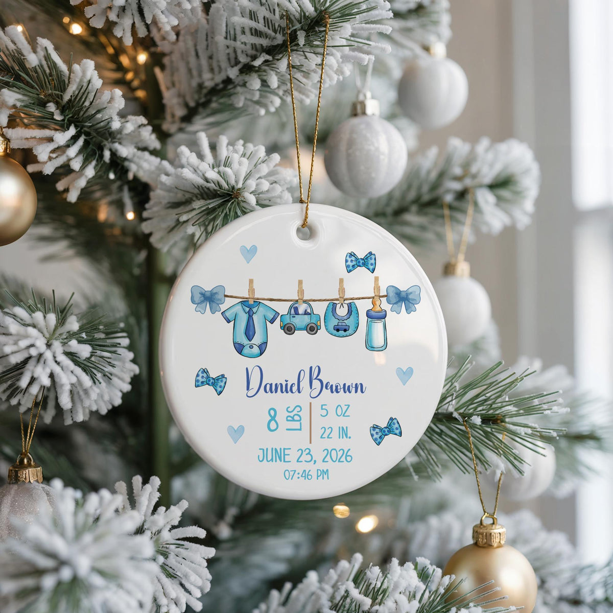 Round ornament with baby clothes on a line and personalized birth details