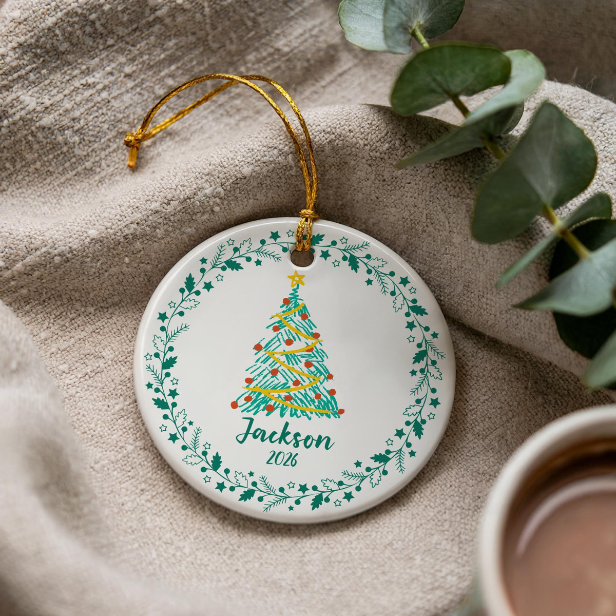 Round ornament with a Christmas tree and a personalized name